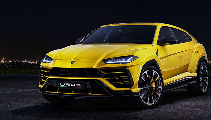 Foto de um Lamborghini Urus amarelo.